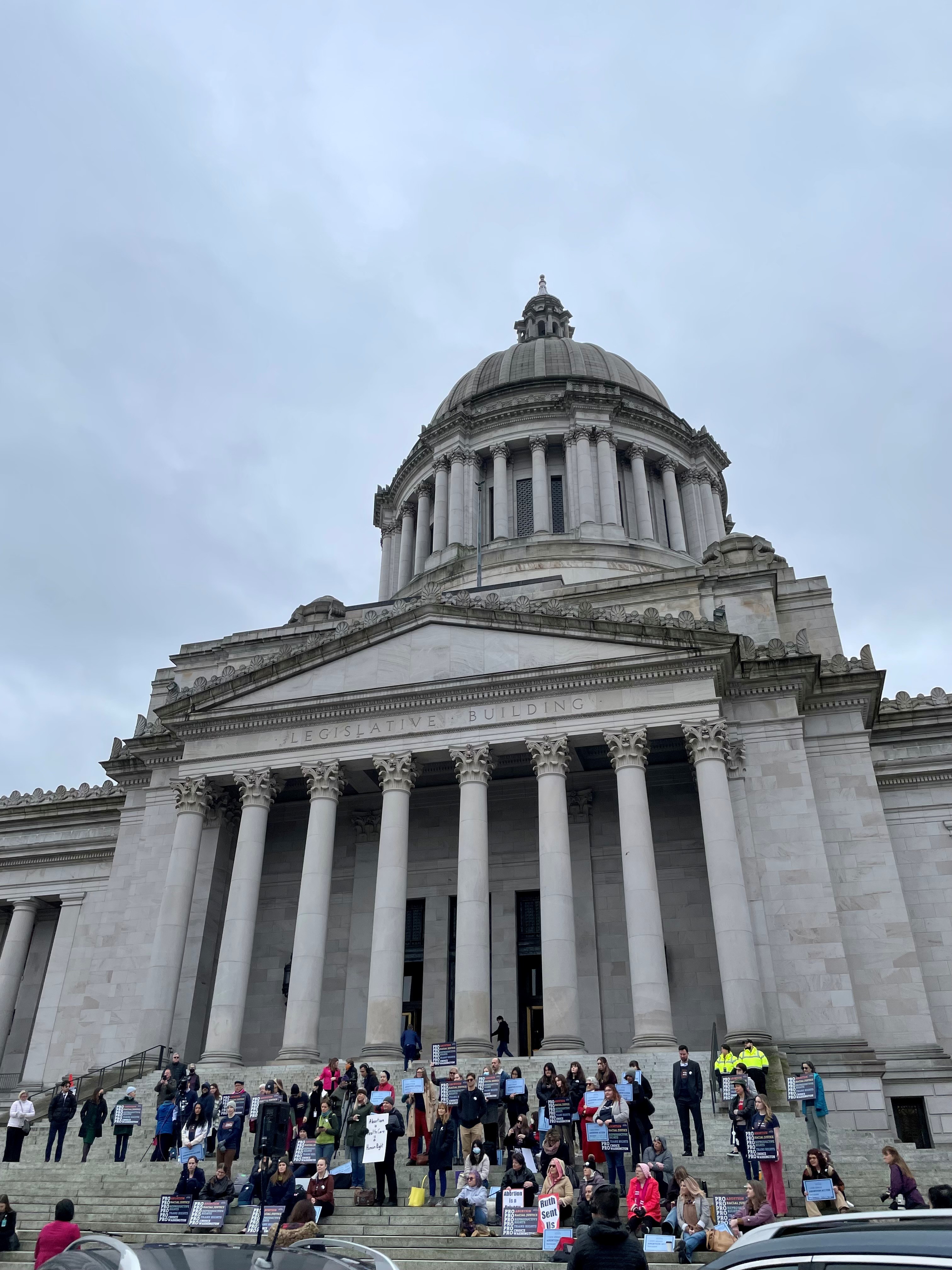 People on the steps of the capitol building in Olympia