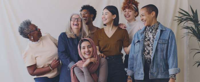 Group of diverse, multigenerational women laughing & smiling