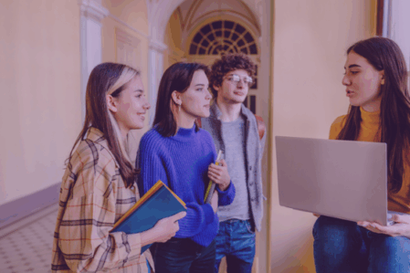 Group of four high school students chat in the hallway