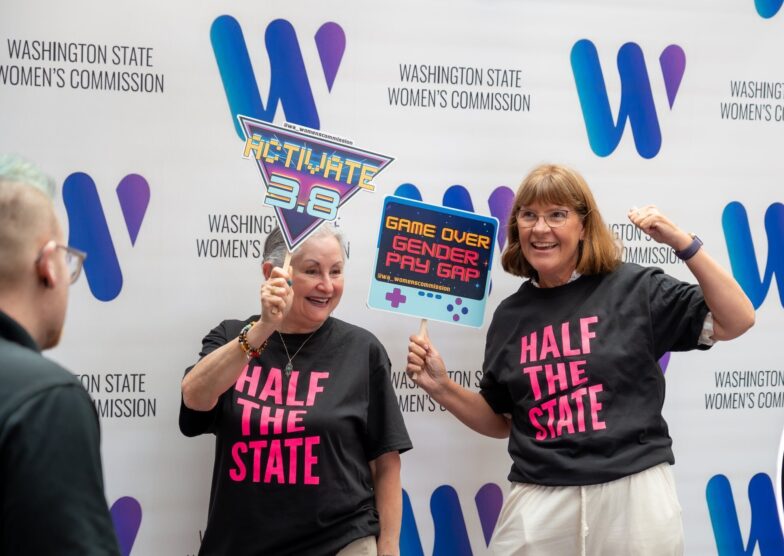 Volunteers pose in front of WSWC step and repeat holding signs.