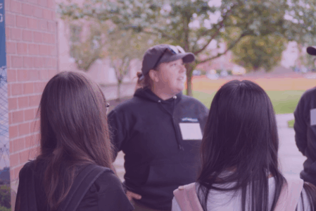 Students learn from land surveyor professional Students learn from a land surveying professional.